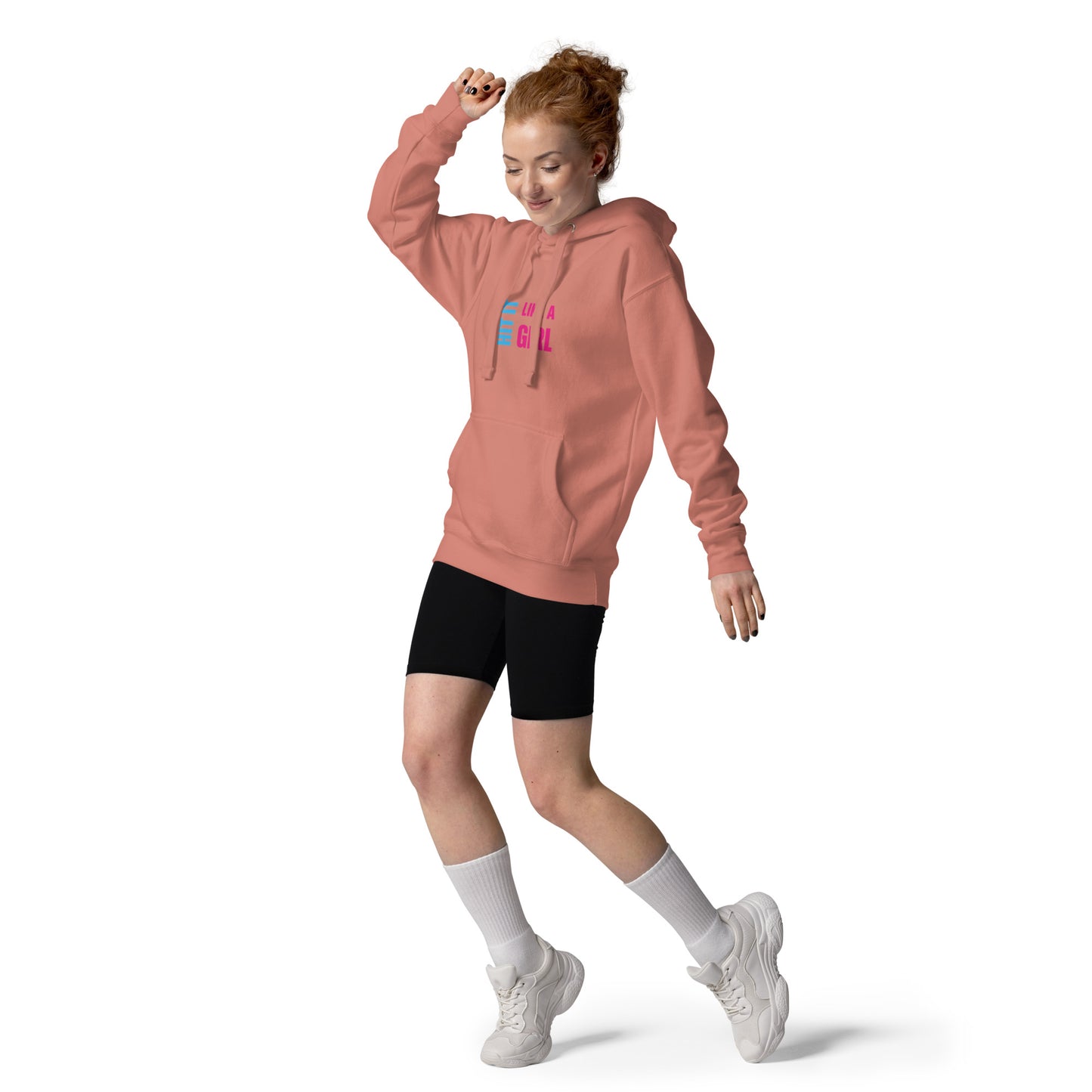 “Hit It Like a Girl” pink hoodie worn by redhead woman mid-motion — confident and cozy activewear for strong, stylish athletes.