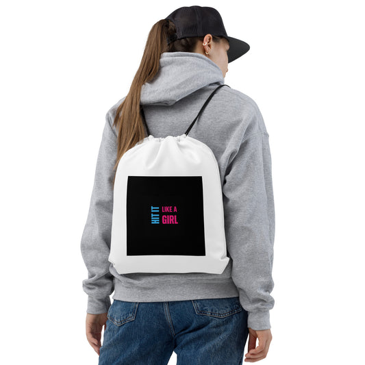 Back view of sporty woman in hoodie and cap wearing Hit It Like a Girl cinch bag — empowering streetwear accessory for active women on the move.