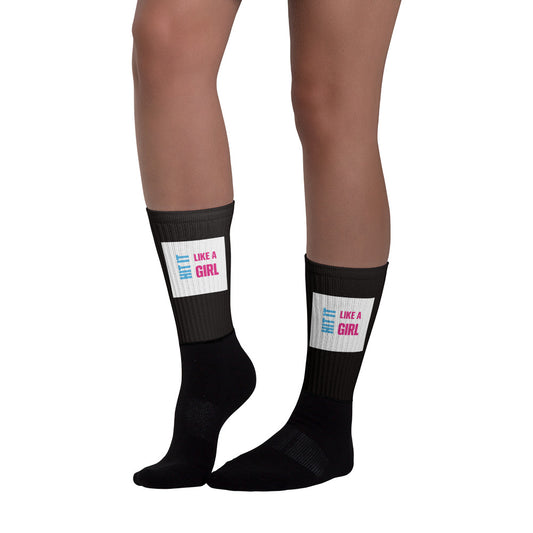 Women’s sports socks with bold Hit It Like a Girl text — black compression-style crew socks for fierce play and recovery.