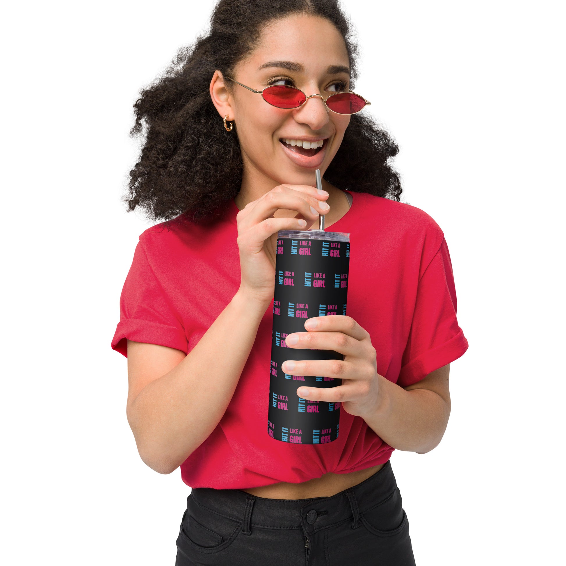 Smiling woman sipping from black Hit It Like a Girl tumbler with all-over logo print — bold and empowering hydration for active lifestyles.