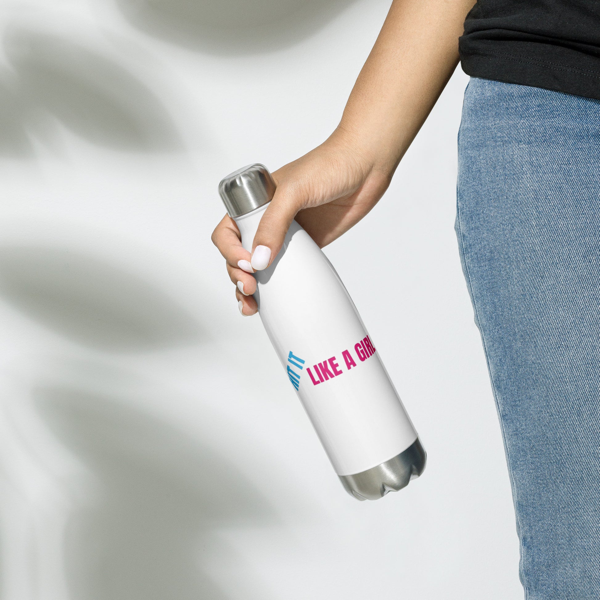 Double-walled white water bottle held in hands, featuring fierce 'Hit It Like a Girl' text—ideal for active, on-the-go women.