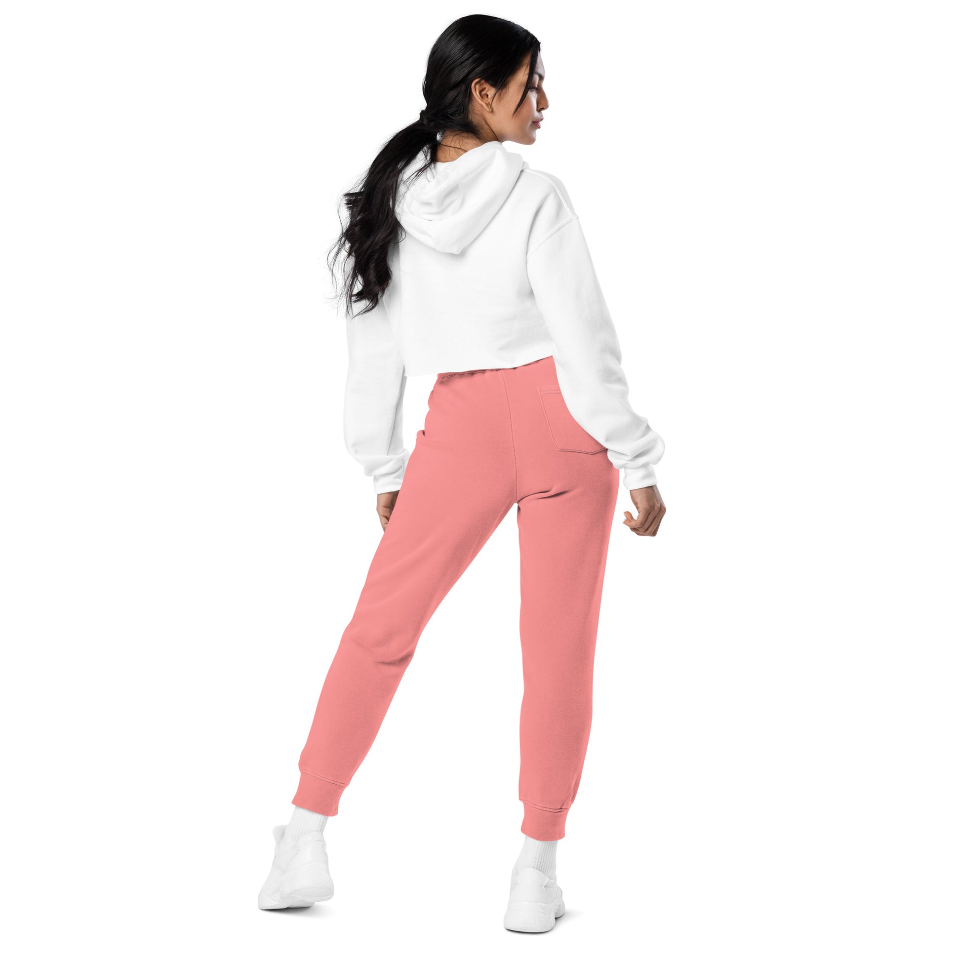 Woman posing in pink joggers designed for confident, active women athletes