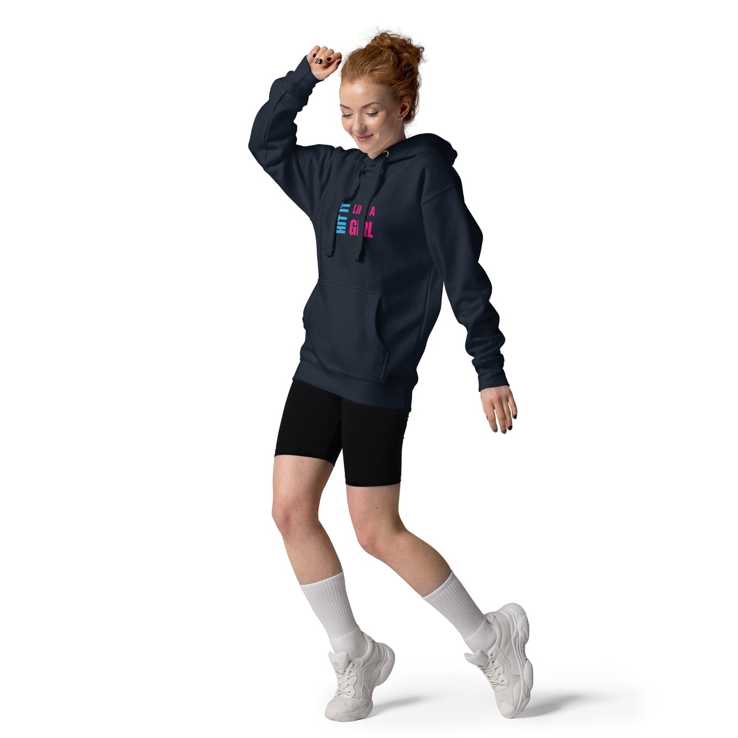 Woman dancing in navy “Hit It Like a Girl” hoodie with bold logo, styled with black shorts and sneakers — empowering athletic streetwear for women.