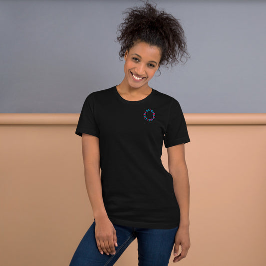 Woman wearing a vintage black "Hit It Like a Girl" athletic tee with bold blue and pink lettering on the back, standing confidently in casual jeans.